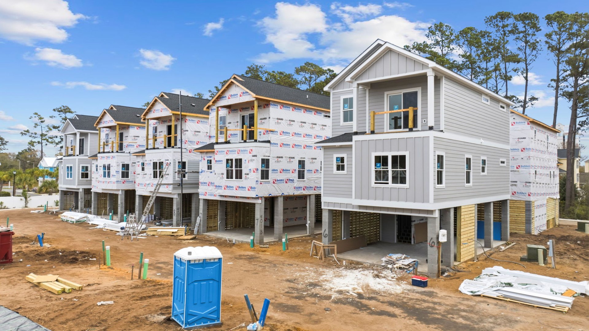 Row of raised beach homes lined along Flounder Way